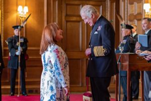 Lynne Rowley, NHS Forth Valley Orthotics Team Lead, is presented with her MBE by HRH King Charles III