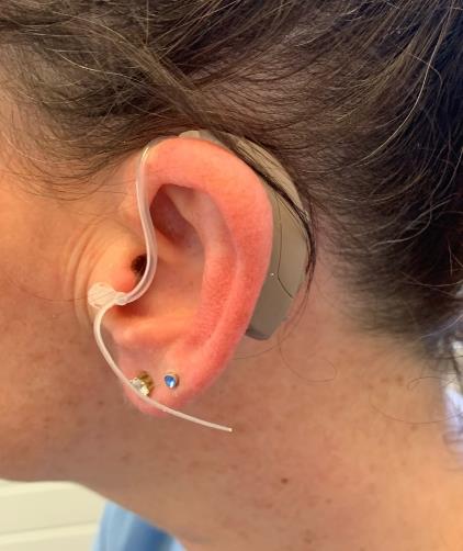 Place the hearing aid behind your ear