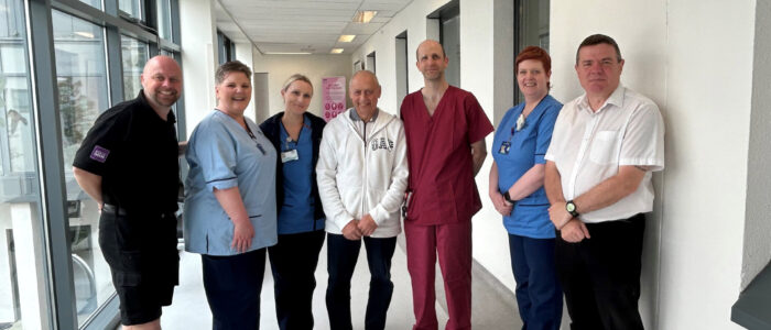 John Main, middle, and Barry Main, far left, join surgeon Alistair Geraghty, stoma care nurse Jennifer Thomson, staff from our oncology support team and representatives of the Jolly Beggars Burns Club