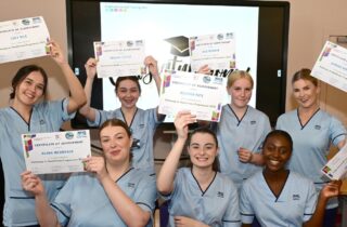 Healthcare Academy graduates celebrate with their certificates at Grangemouth Municipal Chambers.