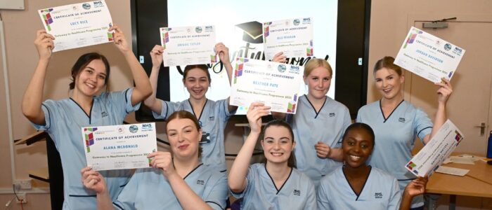 Healthcare Academy graduates celebrate with their certificates at Grangemouth Municipal Chambers.